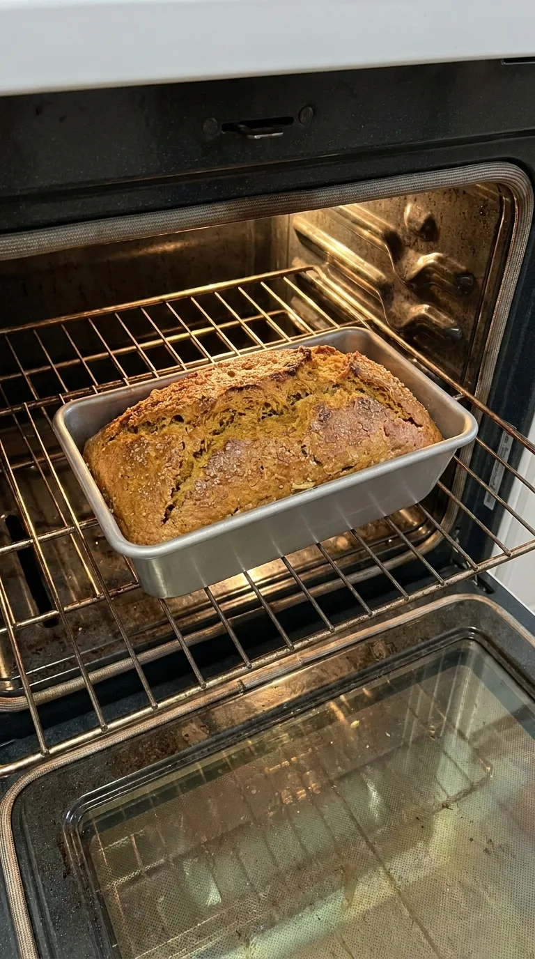 A freshly baked loaf of artisan sourdough pumpkin apple bread with a crispy crust and tender spiced crumb. - View 7
